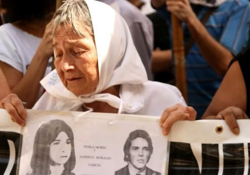 Mother of Plaza de Mayo with photos of missing children